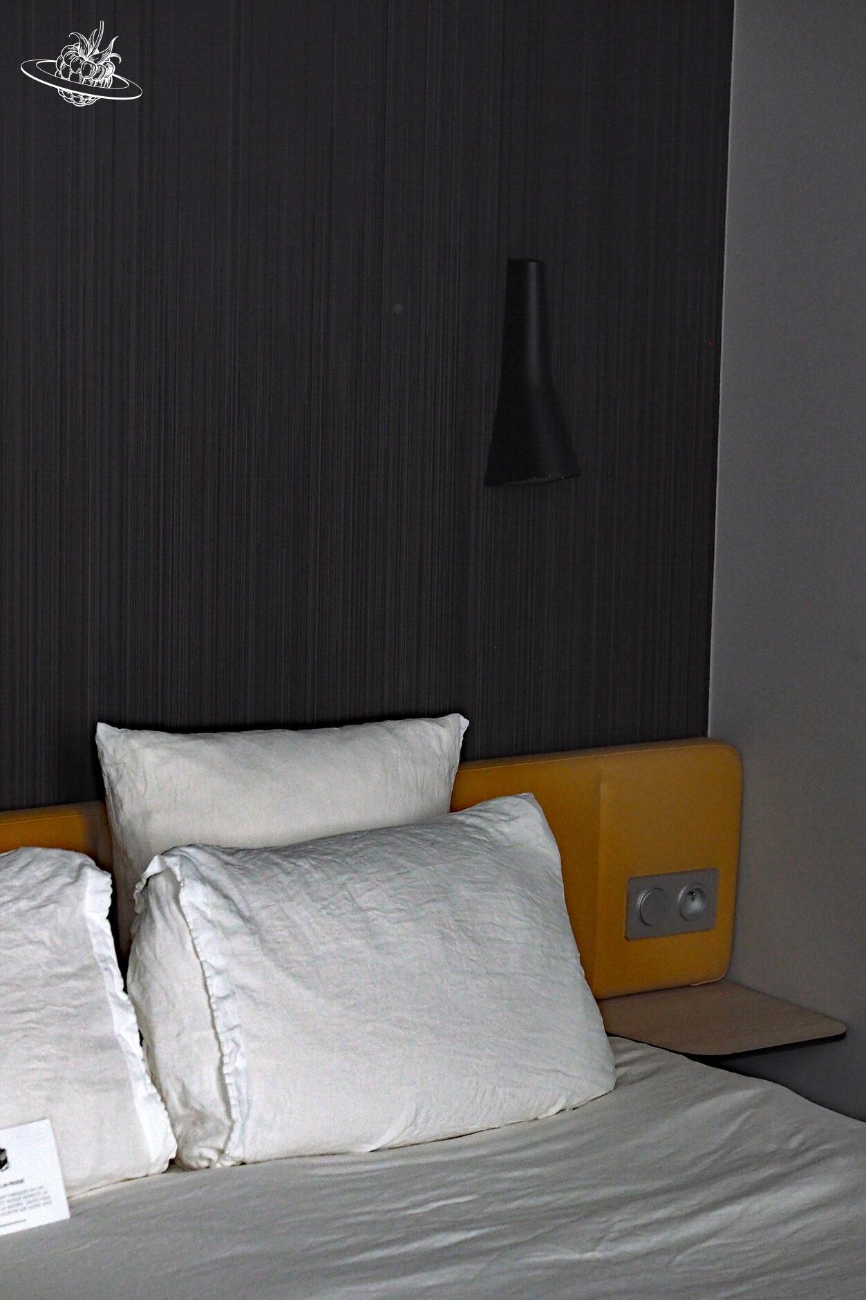 Blick auf das Bett und das Nachttischchen